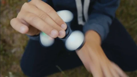 A boy plays with fidget spinner slow motion Video stock 76649150