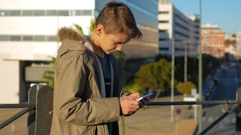 The boy plays the game on a smartphone Stock-Footage 83840974