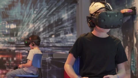 A boy plays a game in virtual reality glasses Stock Footage 142569847