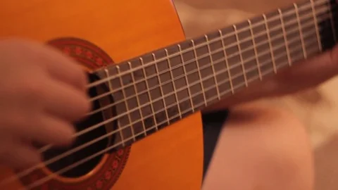 The boy plays the guitar close-up Stock Footage 81860448