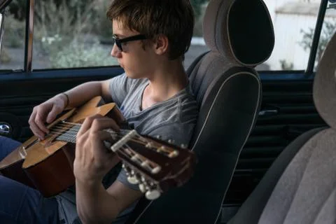 Boy plays the guitar Stock Photos