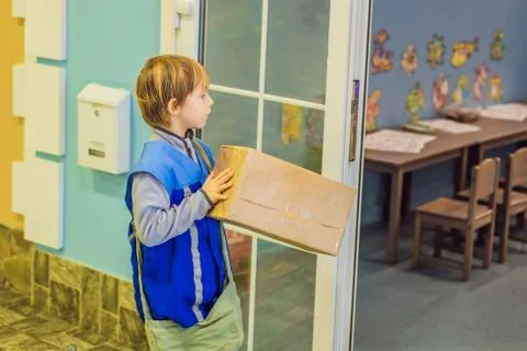 The boy plays that he is a postman Stock Photos