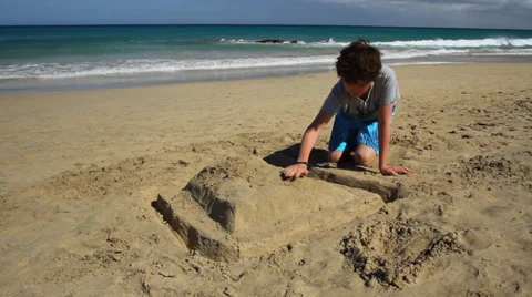 Boy plays on hot sandy beach Stock Footage 39246925