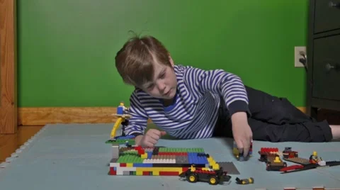 Boy plays with Lego Stock Footage 46969971