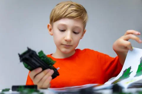 A boy plays with a plastic constructor Foto stock