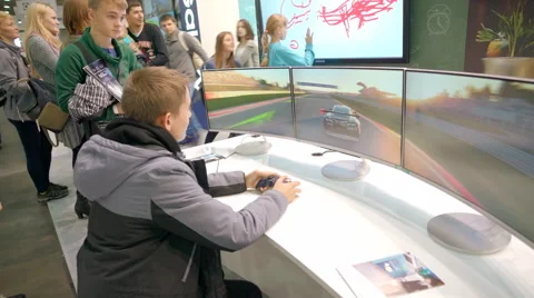 A Boy Plays in the Race on the Console. he Keeps Gamepad Hands Stock Footage 68384986