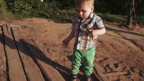A boy plays with sand 스톡 동영상 133630210