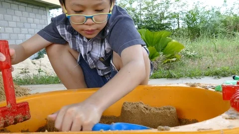 Boy plays with sand at home. Stock Footage 71165019