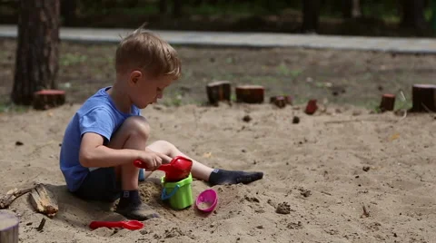 A boy plays in the sandbox Stock Footage 65153985