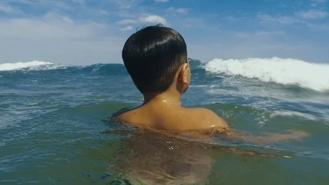 The boy plays in the sea waves Stock Footage 81081263