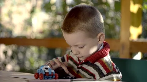 A boy plays on a smart phone outdoor Stock Footage 42425778