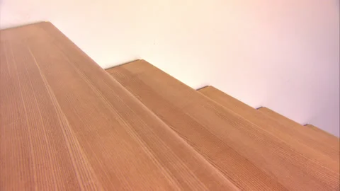 Boy plays on stairs, steps up and down, sliding down, funny video Stock Footage 130348134