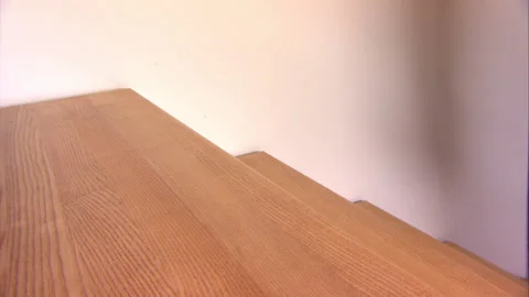 Boy plays on stairs, steps up and down, sliding down, funny video Stock Footage 130348350