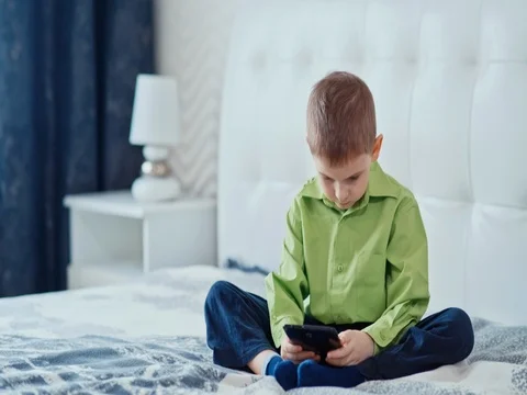 A boy plays on the tablet. Slow motion Vídeos de archivo 73774449