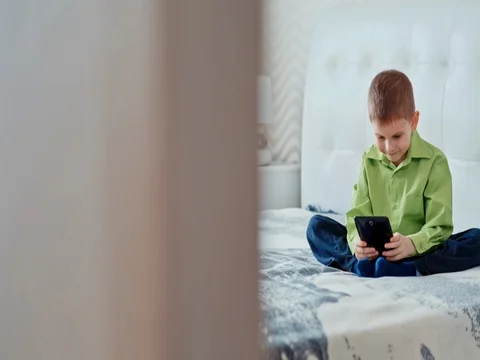 A boy plays on the tablet. Slow motion 스톡 동영상 73774642