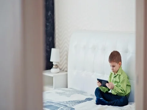 A boy plays on the tablet. Slow motion Stock Footage 73774881