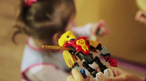A boy plays with a toy robot transformer Video stock 53748080