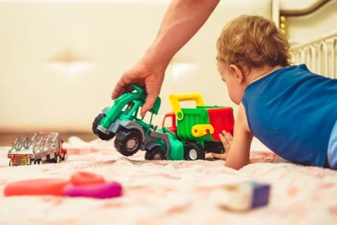 A boy plays with a tractor Stock Photos
