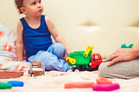 A boy plays with a tractor Stock Photos