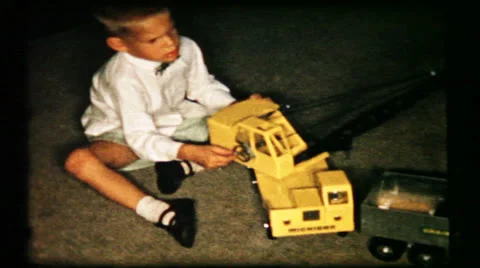 Boy plays with trucks on living room floor  1950s vintage home movie  85 Stock Footage