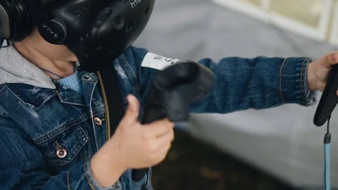The boy plays in a virtual reality helmet. Close up. Children's entertainment. Stock Footage 114536215