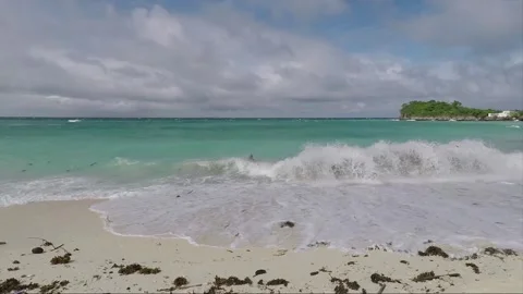 Boy plays with waves in the water on sandy beach, Malapascua island, Philippines Video stock 246494059