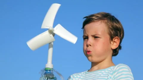 Boy plays with a wind-driven generator against sky Stock Footage 992790