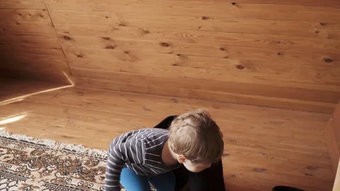 Boy plays with woolen boots Stock Footage 129664943