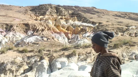 Boy pointing to rock formation. Video stock 27736635