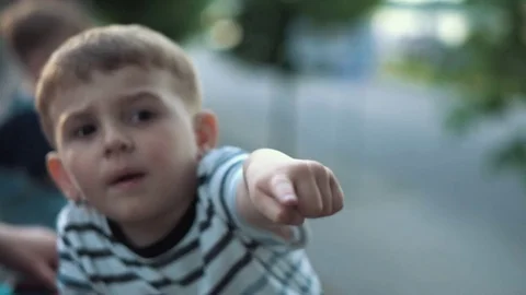 Boy pointing at something , focus shift Stock Footage 79926992
