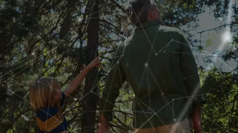 Boy pointing at trees showing interest, man turning and handholding, node Stock Footage 333936353