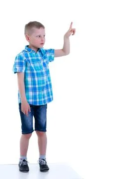 The boy points a finger at something. Stock Photos