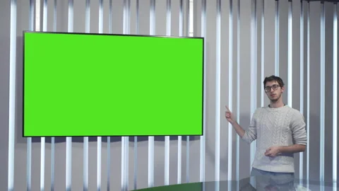 Boy points to the green screen and nods Video stock 144246317
