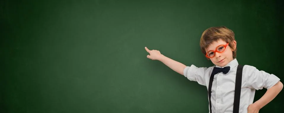 Boy points his finger at an empty blackboard banner Stock Photos