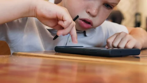 Boy points his finger at smartphone screen. Stock Footage 287988546