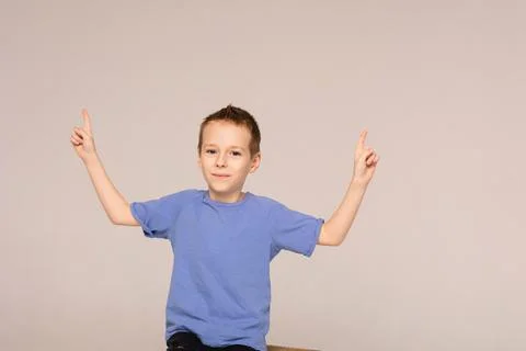 The boy points with his hands to the important. Stock Photos