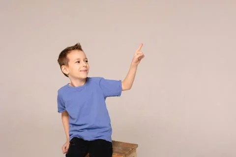 The boy points with his hands to the important. Stock Photos