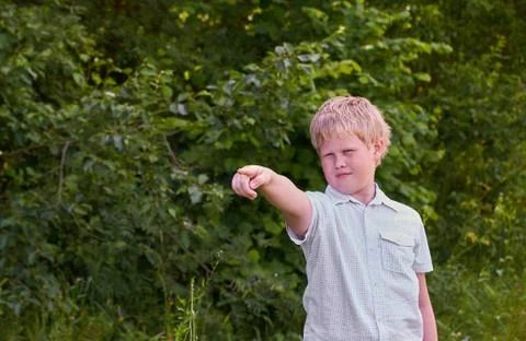 A boy points somewhere with his finger on a walk in the Park Stock Photos