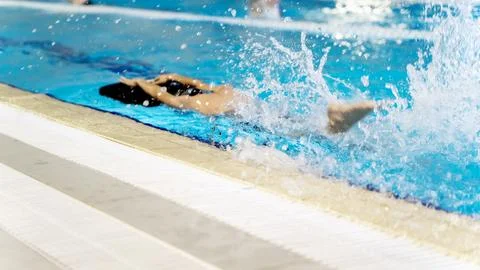 Boy in the pool learning to swim 스톡 사진