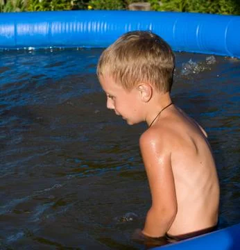 Boy in pool. Stock Photos