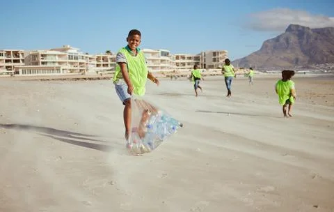 Boy, portrait and trash collection bag in beach waste management, ocean clean up Stock Photos
