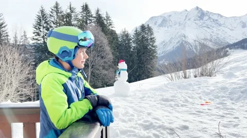 Boy on pose at balcony smile in ski outfit glasses and helmet Vidéo 196011377