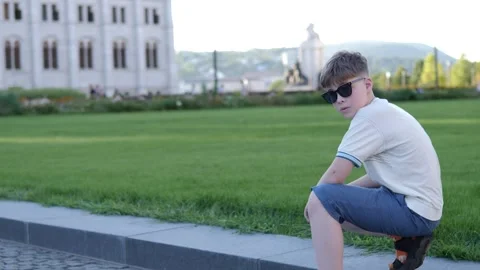 A boy poses in one of Budapest's busy squares, capturing the charm Stock Footage 283630131