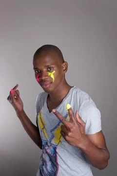 Boy posing with colorful face Stock Photos