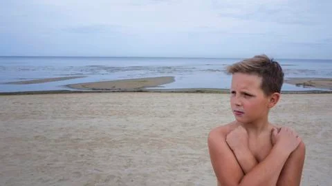 A boy posing on the seashore. Stock Photos