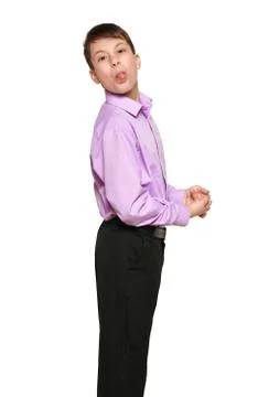 Boy posing on white background, black trousers and purple shirt Stock Photos