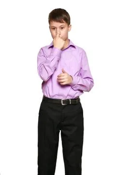 Boy posing on white background, black trousers and purple shirt Stock Photos