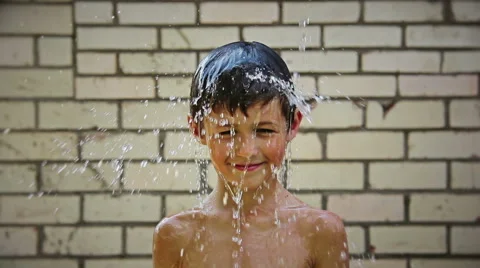 boy pours water, naked boy pours water, | Stock Video | Pond5