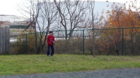 Boy practices baseball in the park Stock Footage 70029368