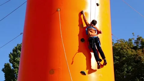 Boy practicing climbing Stock Footage 129038810